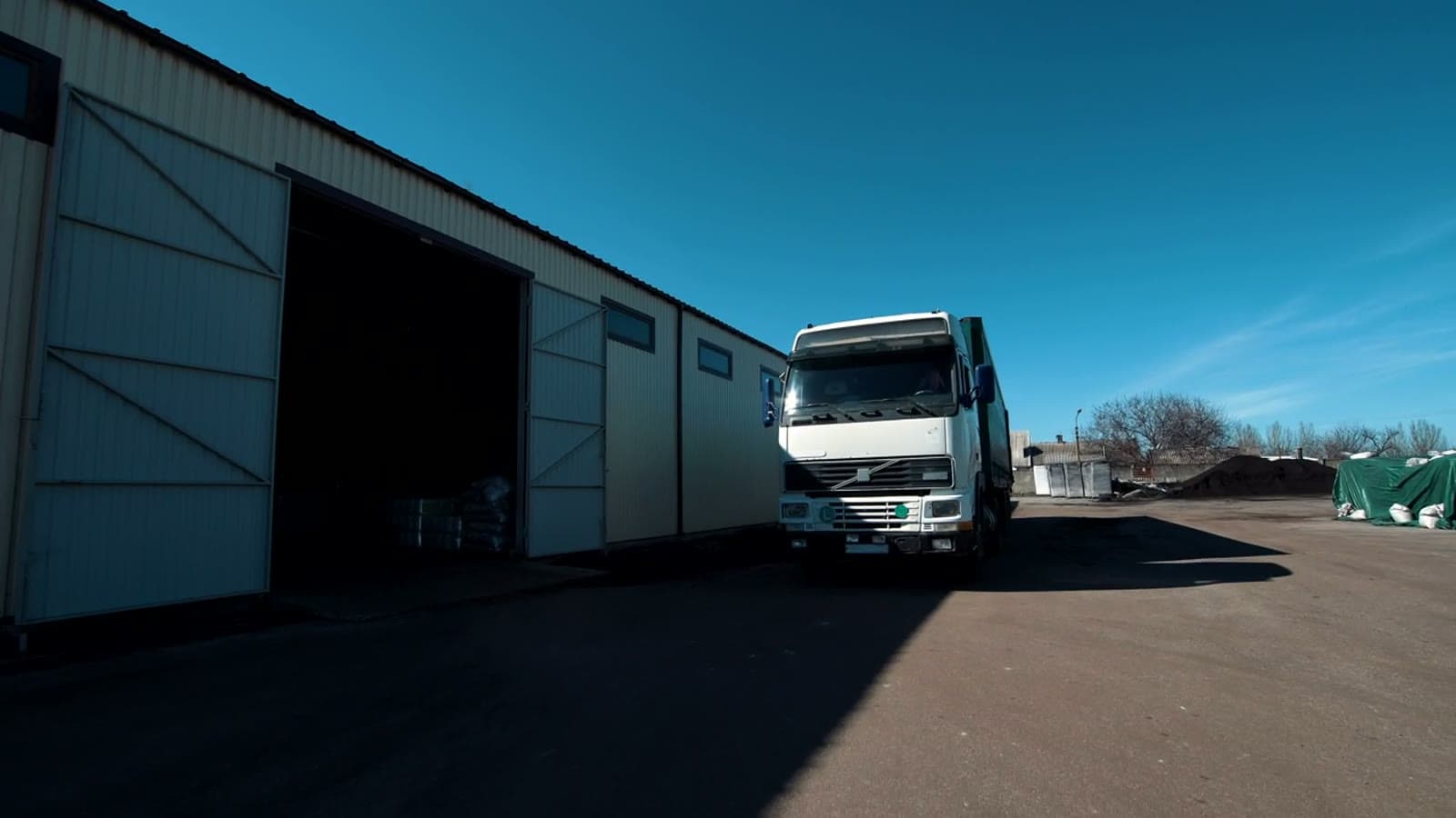 Freight truck backing into a warehouse loading dock